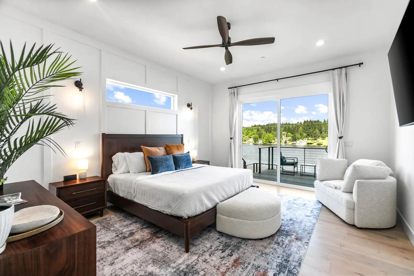 Main-level primary suite with private balcony overlooking the lake at Luxe Port Lookout